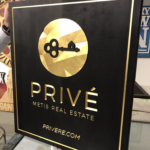 Black and gold custom signage for Prive real estate