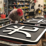 Painting custom business signage for an apartment complex
