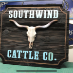 Custom wood signage of a longhorn skull for Southwind Cattle Co.