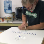 Painting custom business signage for Vista Blue Spa