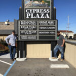 The custom business sign for Cypress Plaza