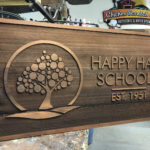 A custom wood business sign for Happy Hall Schools
