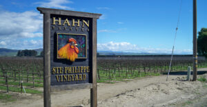 A winery sign with a bright rooster on it