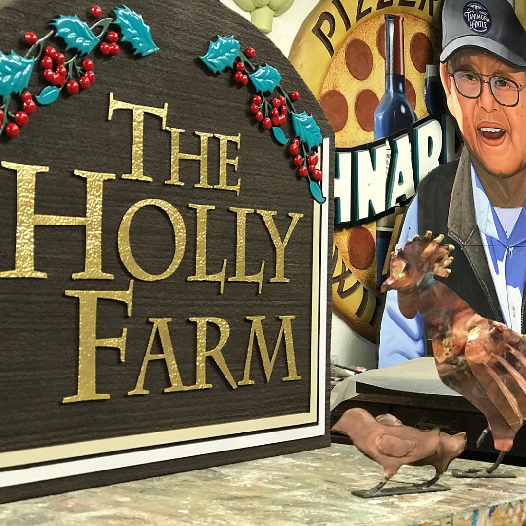 3D sign reading "The Holly Farm" with holly leaves and berries